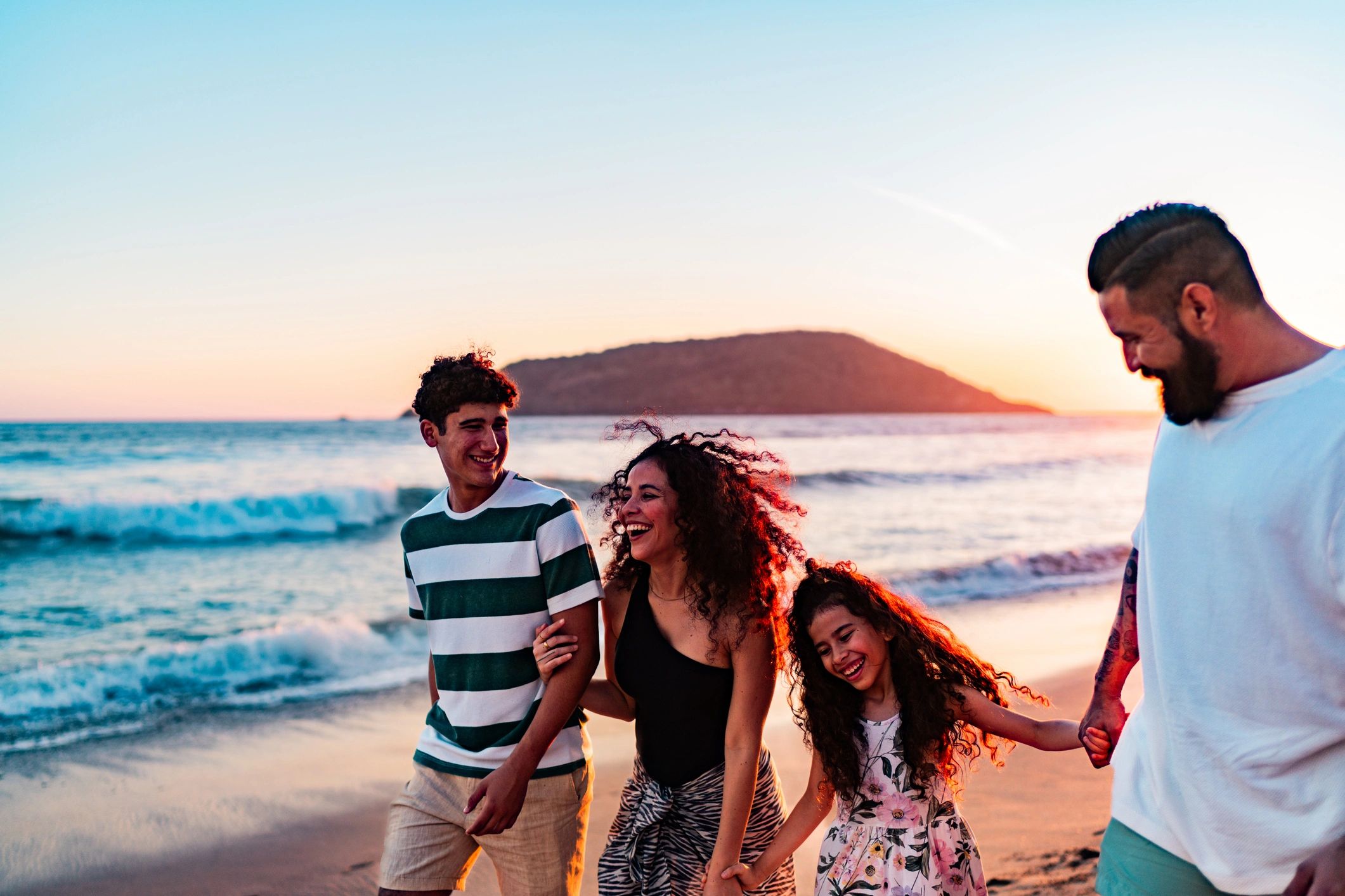 Family walking on the beach representing family and group travel